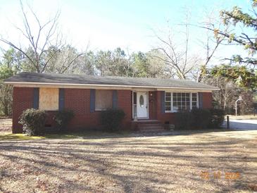 Charming single-story brick home with manicured bushes and a white front door at 12 E Sassafras St., Andrews, SC 29510