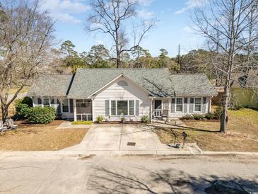 Charming single-story home with white siding, gray shutters, and a well-maintained front yard at 17 Racquet Club Dr., Pawleys Island, SC 29585