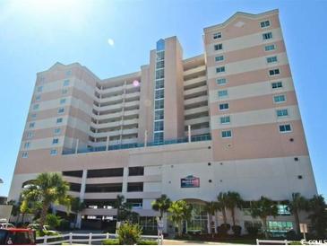 Low-angle view of Crescent Keyes resort, a tall tan-colored building in Myrtle Beach at 1903 S Ocean Blvd. # 701, North Myrtle Beach, SC 29582