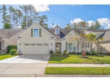 Charming single-story home with a well-manicured lawn, attached garage, and inviting curb appeal at 2122 Silver Spring Ln., Myrtle Beach, SC 29577