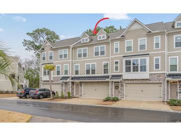 Attractive multi-level townhouse with a combination of stone and siding and a convenient single car garage at 2557 Pete Dye Dr. # 702, North Myrtle Beach, SC 29582