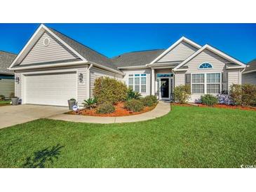 Charming home featuring a well-maintained lawn and two-car garage at 257 Leste Rd., Myrtle Beach, SC 29588