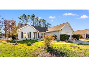 Charming single-story home boasts manicured lawn and a welcoming entrance, perfect for suburban living at 1501 Hallborough Dr., Surfside Beach, SC 29575