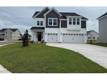 Beautiful two-story home featuring a spacious three-car garage and manicured lawn at 4019 Bucolic Loop, Myrtle Beach, SC 29588