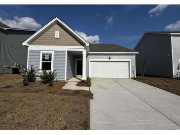 Charming single-story home with vinyl siding and a two-car garage on a sunny day at 516 Tillage Ct., Conway, SC 29526