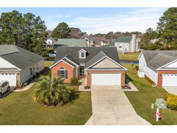 Charming single Gathering home featuring brick accents, attached two-car garage, and well-maintained landscaping at 658 Pamlico Ct., Myrtle Beach, SC 29588