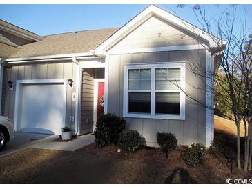 Charming home featuring a single-car garage, neat landscaping, and a welcoming entrance at 8 Vineyard Place # 1, Pawleys Island, SC 29585