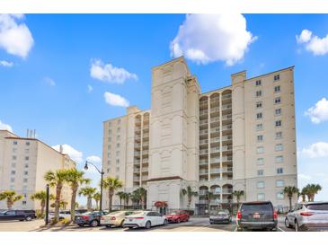 Stunning condominium complex with parking and palm trees against a clear blue sky at 2151 Bridge View Ct. # 11003, North Myrtle Beach, SC 29582
