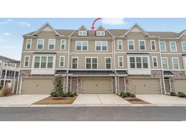 Charming townhome with a two-car garage, stone accents, neutral paint, and beautiful curb appeal at 2557 Pete Dye Dr. # 402, North Myrtle Beach, SC 29582