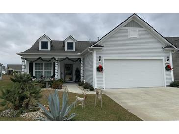 Charming one-story home featuring a well-maintained lawn, two-car garage, and holiday decorations at 4321 Hawkins Dr., Myrtle Beach, SC 29579