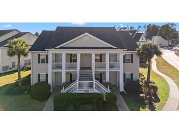 Charming two-story condo with classic architecture and beautifully landscaped front yard at 4929 Pond Shoals Ct. # 201, Myrtle Beach, SC 29579