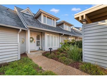 Charming home featuring a stone walkway, landscaped garden, and welcoming front door with a decorative wreath at 601 Gloucester Terrace Circle # 3C, Myrtle Beach, SC 29572