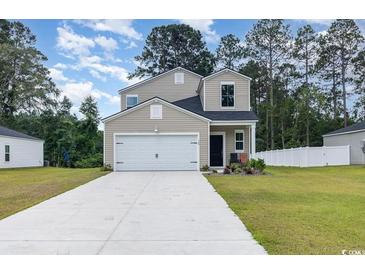 Charming two-story home with a spacious driveway and an attached two-car garage in a well manicured lawn at 120 Carolina Lakes Blvd., Myrtle Beach, SC 29588