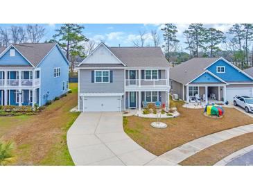 Charming two-story home with a covered porch, manicured lawn, and attached two-car garage at 2593 Pegasus Place, Myrtle Beach, SC 29577