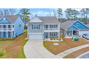 Charming two-story home features a welcoming front porch, manicured lawn, and private driveway at 2593 Pegasus Place, Myrtle Beach, SC 29577