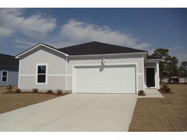 Charming single-story home featuring a two-car garage and neutral siding at 272 Warner Crossing Way, Loris, SC 29569