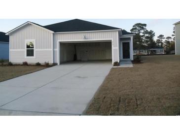 Home featuring a wide driveway leading to an attached, two-car garage for easy parking and storage at 272 Warner Crossing Way, Loris, SC 29569