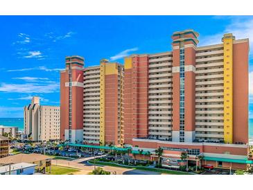 Beautiful exterior view of a condo complex, with a parking lot and vibrant blue skies at 2801 S Ocean Blvd. # 733, North Myrtle Beach, SC 29582