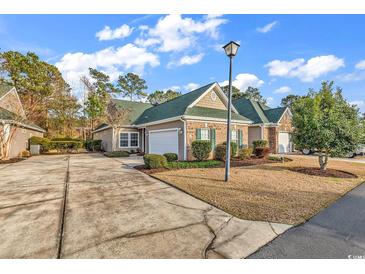 Charming one-story home with a well-maintained lawn, attached garage and neutral beige exterior at 300 Nuthatch Ln. # A, Murrells Inlet, SC 29576