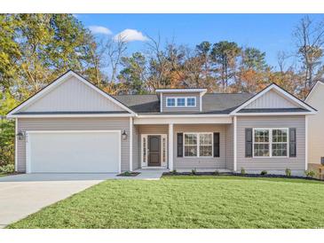 Charming single-story home featuring a gray exterior, attached garage, and well-manicured lawn at 383 West Dogwood Rd., Loris, SC 29569