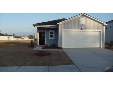 Charming single-Gathering home with a two-car garage, manicured lawn, and modern blue siding at 448 Ribbon Rail Way, Loris, SC 29569