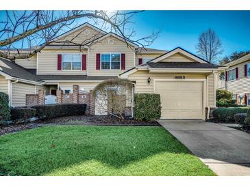 Charming townhouse with a one-car garage, red shutters, and a well-maintained lawn in a desirable neighborhood at 4498 Girvan Dr. # D, Myrtle Beach, SC 29579