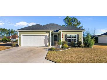 Charming single-story home with a well-manicured lawn, attached garage, and inviting landscaping at 685 Tidal Point Ln., Myrtle Beach, SC 29579