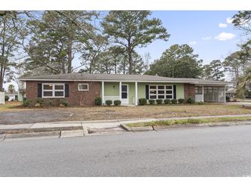 Charming single-story home with a combination of brick and wood siding, with a covered carport at 693 Mallard Lake Dr., Myrtle Beach, SC 29577