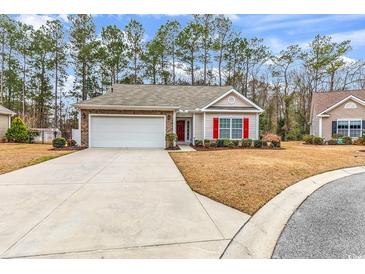 Charming single-story home featuring a two-car garage, red shutters, and well-maintained landscaping at 817 Riverwood Ct., Little River, SC 29566