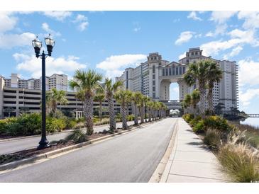 Scenic view of the resort exterior, featuring palm trees lining the road and architecture with skybridge at 100 North Beach Blvd. # 506, North Myrtle Beach, SC 29582
