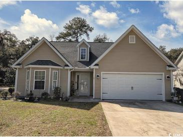 Charming single-story home featuring a two-car garage and a well-maintained front yard on a sunny day at 13 Daniel Morrall Ln., Georgetown, SC 29440