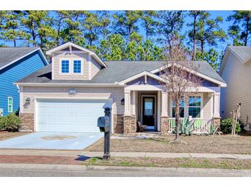 Charming single-Gathering home with stone accents, front porch, and two-car garage at 1878 Heritage Loop, Myrtle Beach, SC 29577
