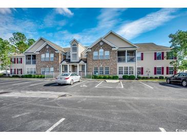 Attractive multi-Gathering residential building with brick accents, balconies, and ample parking under a blue sky at 200 Vendura Ct. # B, Murrells Inlet, SC 29576