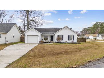 Charming one-story white home with a well-manicured lawn, attached garage and inviting curb appeal at 453 Saint Charles Circle, Myrtle Beach, SC 29588