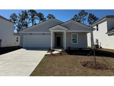 Charming single-story home boasts a well-manicured lawn, attached garage, and inviting front entrance at 981 Laconic Dr., Myrtle Beach, SC 29588