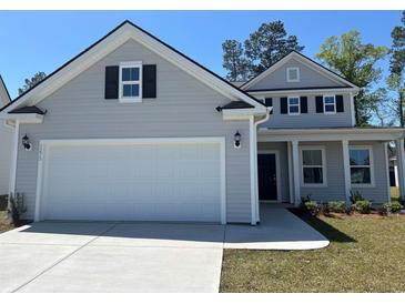 Charming two-story home featuring a two-car garage and a well-maintained lawn, perfect for families at 1275 Winding Creek Way, Myrtle Beach, SC 29588