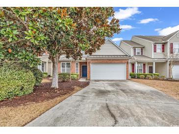 Charming two-story home featuring a brick facade, attached two-car garage, and well-manicured landscaping at 1547 Harlow Ct., Myrtle Beach, SC 29579