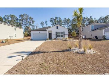 Charming single-story home with a well-maintained lawn, a driveway, and a one car garage at 184 Carolina Lakes Blvd., Myrtle Beach, SC 29588