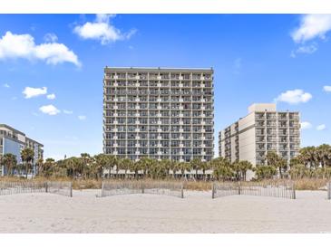 Stunning exterior view of oceanfront high-rise condominium complex with palm trees at 2300 N Ocean Blvd. # 1037, Myrtle Beach, SC 29577