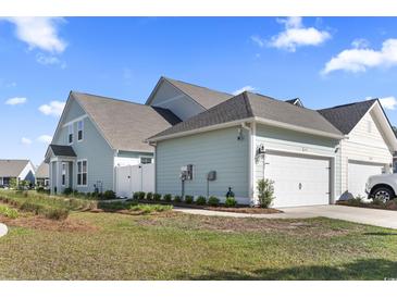 Charming home features a manicured lawn, two-car garage, and welcoming exterior at 2476 Blue Crane Circle # 101, Myrtle Beach, SC 29577
