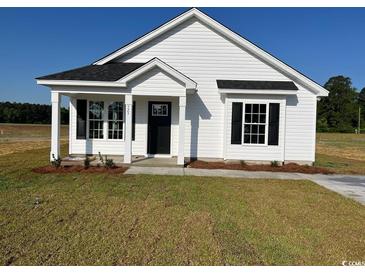 Charming single-story home with a welcoming front porch, black shutters, and new landscaping at 2582 Cottonwood Dr., Loris, SC 29569