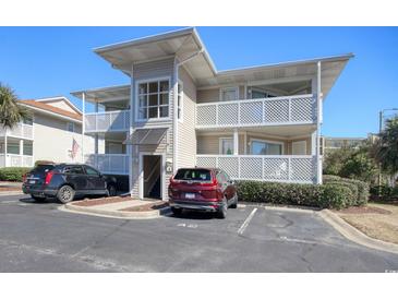 Inviting condo featuring multiple balconies with white railings and convenient parking spaces at 300 Shorehaven Dr. # A4, North Myrtle Beach, SC 29582