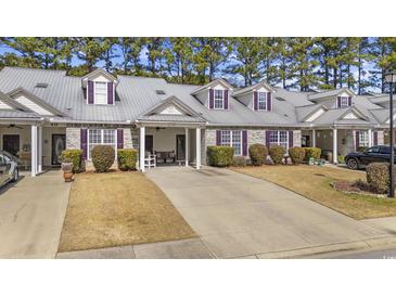 Charming townhome with a well-manicured lawn and a private driveway at 437 Colonial Trace Dr. # 2C, Longs, SC 29568