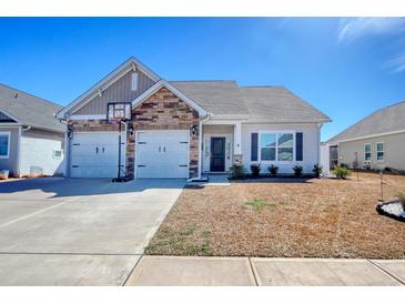 Charming single-Gathering home with a two-car garage and well-maintained front yard on a sunny day at 568 Canborough Lane, Murrells Inlet, SC 29576