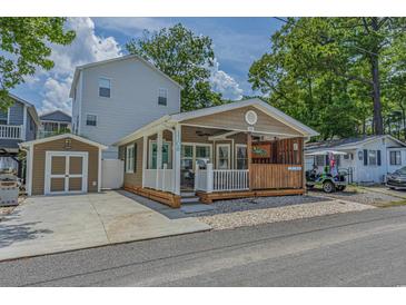 Charming single-story home with a cozy front porch, quaint architectural details, and a detached garage at 6001 - 1308 S Kings Hwy., Myrtle Beach, SC 29575