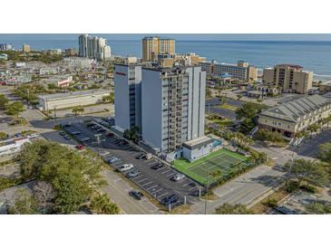 Aerial shot of condo building with a tennis court, parking lot, and close proximity to the beach at 601 Mitchell Dr. # 808, Myrtle Beach, SC 29577