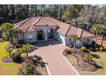 Stunning aerial view of the beautiful red-roofed home and landscaped yard, creating a luxurious curb appeal at 8285 Leone Circle, Myrtle Beach, SC 29579