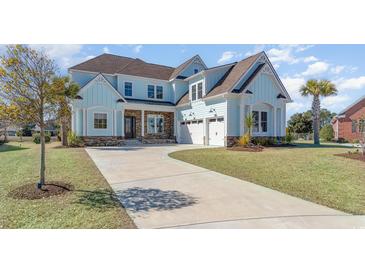 Charming two-story home with light blue siding, stone accents, three-car garage, and large driveway at 1042 Muscovy Pl., Conway, SC 29526