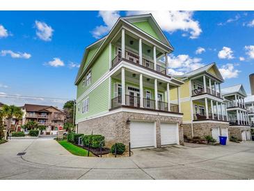 Charming, multi-story home featuring a brick base, double balconies, and attached two-car garage at 316 Shuffleboard Ct., Myrtle Beach, SC 29572