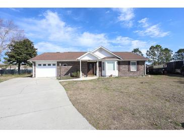 Charming brick home features an attached garage and a well-manicured front lawn at 4339 Dew N. Ct., Myrtle Beach, SC 29579